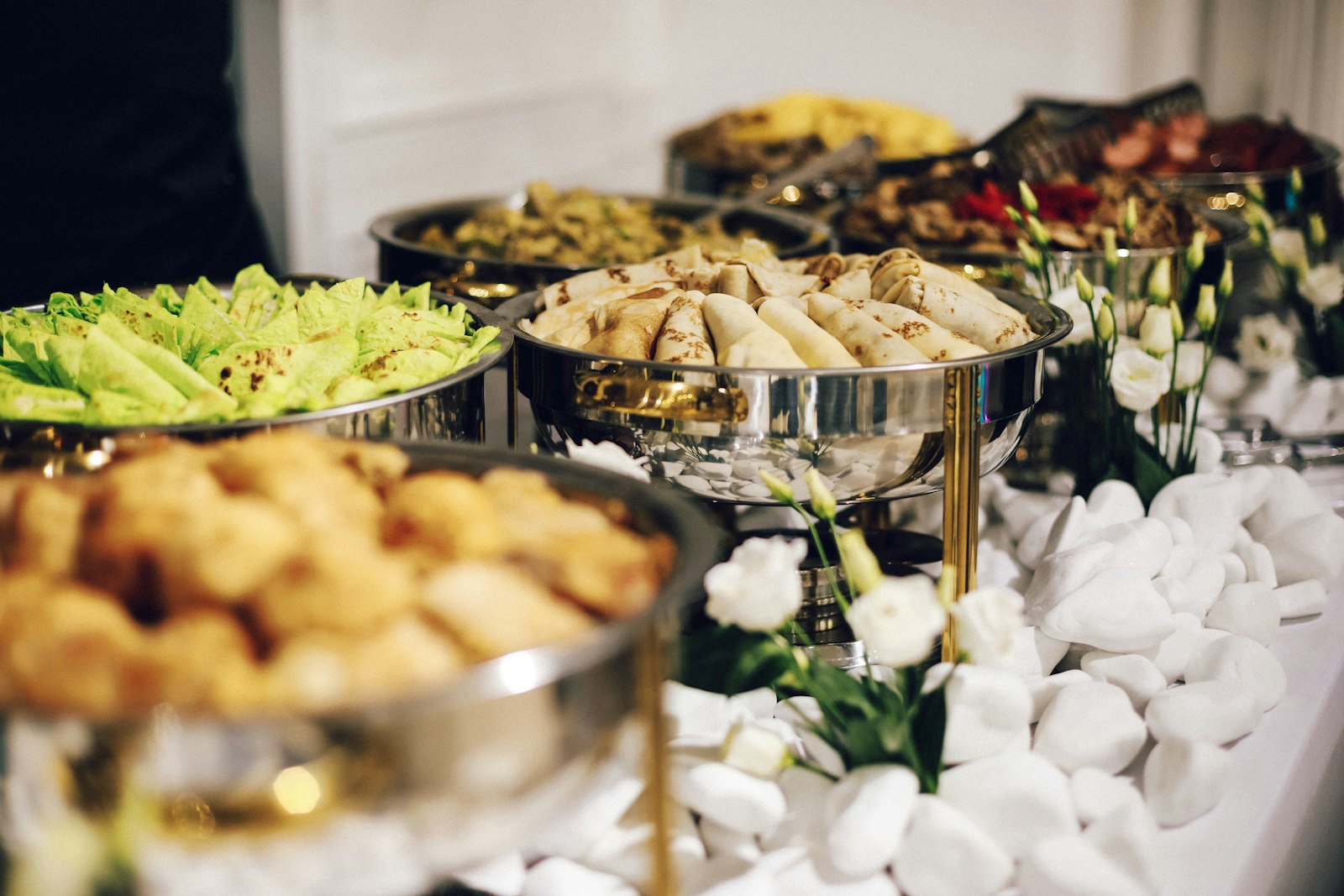 Warm luxury catering buffet with elegant tableware